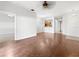 Open living room with wood-look flooring and views of kitchen and hallway at 3473 Parkridge Cir # 17-101, Sarasota, FL 34243