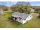 White house with gray roof, large yard, and trees at 2205 Mcgee Rd, Plant City, FL 33565