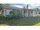 White single story home with red trim and American flag at 2205 Mcgee Rd, Plant City, FL 33565