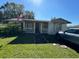 White single-story house with front porch and American flag at 2205 Mcgee Rd, Plant City, FL 33565