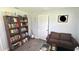 Home office features built-in shelving, a comfortable couch, and plenty of natural light at 2205 Mcgee Rd, Plant City, FL 33565