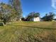 Large grassy yard with house and outbuildings at 2205 Mcgee Rd, Plant City, FL 33565