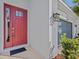 Red front door with glass panels and a gray garage door at 10395 Boyette Brook St, Riverview, FL 33569