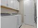 Laundry room with washer, dryer, and ample cabinet storage at 10395 Boyette Brook St, Riverview, FL 33569