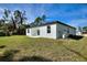 Side view of a house with a covered patio and large backyard at 3580 Richardson Sw St, North Port, FL 34288