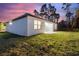 Backyard view of a modern home with a patio and grassy yard at 3580 Richardson Sw St, North Port, FL 34288