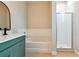 Modern bathroom with teal vanity, white subway tile, and a large walk-in shower at 2729 Walden Woods Dr, Plant City, FL 33566
