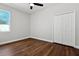 Bedroom with wood-look floors and double door closet at 2729 Walden Woods Dr, Plant City, FL 33566