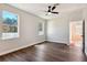Spacious bedroom with wood-look flooring and multiple windows at 2729 Walden Woods Dr, Plant City, FL 33566