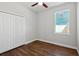 Bedroom with wood-look flooring and a double door closet at 2729 Walden Woods Dr, Plant City, FL 33566