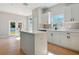 Modern kitchen with white cabinets, quartz countertops, and tile flooring at 2729 Walden Woods Dr, Plant City, FL 33566