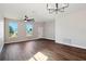 Spacious living room with hardwood floors, ceiling fan, and chandelier at 2729 Walden Woods Dr, Plant City, FL 33566