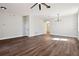 Spacious living room with hardwood floors, ceiling fan, and chandelier at 2729 Walden Woods Dr, Plant City, FL 33566