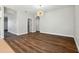 Open living room with hardwood floors, a chandelier, and access to other rooms at 2729 Walden Woods Dr, Plant City, FL 33566