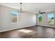 Bright living room featuring hardwood floors, a ceiling fan, and a chandelier at 2729 Walden Woods Dr, Plant City, FL 33566