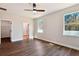 Main bedroom with wood-look floors, ceiling fan, and en-suite bathroom at 2729 Walden Woods Dr, Plant City, FL 33566