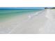 White sand beach with calm, clear water at 7532 Bayshore Dr # 203, Treasure Island, FL 33706