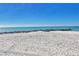 Stunning view of a pristine beach with clear water under a bright blue sky at 7532 Bayshore Dr # 203, Treasure Island, FL 33706