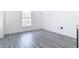 Bright bedroom with large window and grey wood flooring at 9150 Genesee St, Port Charlotte, FL 33981