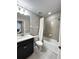 A bathroom showcasing a single vanity, toilet, tub with shower, and tile walls with neutral paint at 2467 Foggy Creek Cir, Clearwater, FL 33764