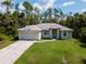 Single-story house with a two-car garage and a spacious yard at 4126 Cobbler Ln, North Port, FL 34286
