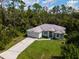 Single-story house with a two-car garage and a grassy yard at 4126 Cobbler Ln, North Port, FL 34286