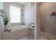 Spa-like bathroom with soaking tub and walk-in shower at 4126 Cobbler Ln, North Port, FL 34286