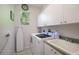 Laundry room with washer, dryer, and utility sink at 4126 Cobbler Ln, North Port, FL 34286