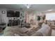 Spacious living room featuring a large sectional sofa and fireplace at 4126 Cobbler Ln, North Port, FL 34286
