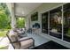Covered patio with seating area and TV at 4126 Cobbler Ln, North Port, FL 34286