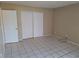 Cozy bedroom with tile flooring and a spacious closet at 4885 Rilma Ave # 130, Sarasota, FL 34234