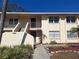 Close up of a charming two-story condo featuring lush landscaping at 4885 Rilma Ave # 130, Sarasota, FL 34234