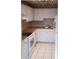 Functional kitchen featuring white cabinets, ample counter space and tiled floors at 4885 Rilma Ave # 130, Sarasota, FL 34234