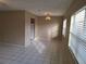 Neutral living room with tile flooring and an elegant light fixture at 4885 Rilma Ave # 130, Sarasota, FL 34234