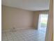 Spacious living room featuring tile floors and sliding glass doors to a patio at 4885 Rilma Ave # 130, Sarasota, FL 34234