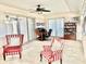 Bright sunroom with comfy chairs and built-in shelving at 705 Brannen Cir, Sun City Center, FL 33573