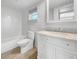 Clean bathroom with white vanity, marble countertop, and a bathtub at 7326 Shepherd St, Sarasota, FL 34243