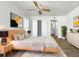 Bright bedroom with light wood platform bed, ceiling fan, and en-suite bathroom at 7326 Shepherd St, Sarasota, FL 34243
