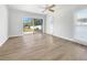 Bright bedroom with sliding doors to backyard and laminate wood flooring at 7326 Shepherd St, Sarasota, FL 34243