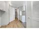 Light and bright hallway with white cabinets and wood flooring at 7326 Shepherd St, Sarasota, FL 34243