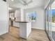 Eat-in kitchen with island, white cabinets, and view of pool at 7326 Shepherd St, Sarasota, FL 34243