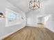 Spacious living area with high ceilings, hardwood floors, and a large window at 7326 Shepherd St, Sarasota, FL 34243