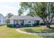 Cute ranch home with a landscaped lawn and a large shade tree at 7710 Danube Dr # A, Hudson, FL 34667