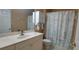 Clean bathroom with single vanity, shower/tub combo, and decorative shower curtain at 1835 Scarlett Ave, North Port, FL 34289