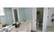 Bright bathroom with double vanity, walk-in shower, and separate toilet at 1835 Scarlett Ave, North Port, FL 34289