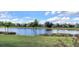 Stunning view of a peaceful lake with lush green landscaping at 1835 Scarlett Ave, North Port, FL 34289