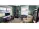 Home office with built-in shelving, comfortable seating, and large windows at 1835 Scarlett Ave, North Port, FL 34289