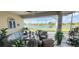 Spacious covered patio overlooking a tranquil lake, perfect for outdoor relaxation at 1835 Scarlett Ave, North Port, FL 34289