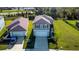 Aerial view of a modern home with a lush green lawn and convenient two-car garage at 9189 Royal River Cir, Parrish, FL 34219