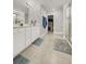 Modern bathroom features double sink vanity, walk-in shower, and walk-in closet at 9189 Royal River Cir, Parrish, FL 34219